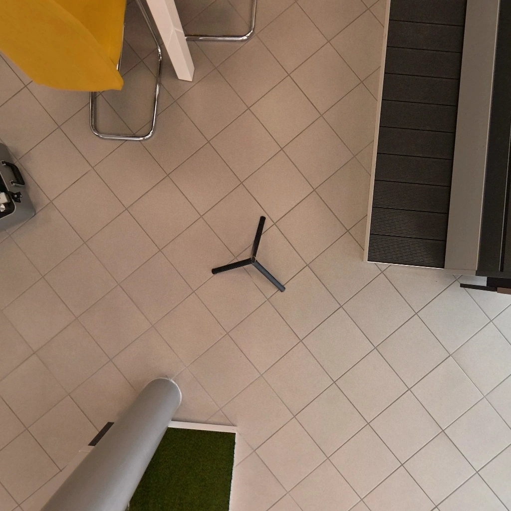Floor of a 360° living room with a tripod visible under the camera